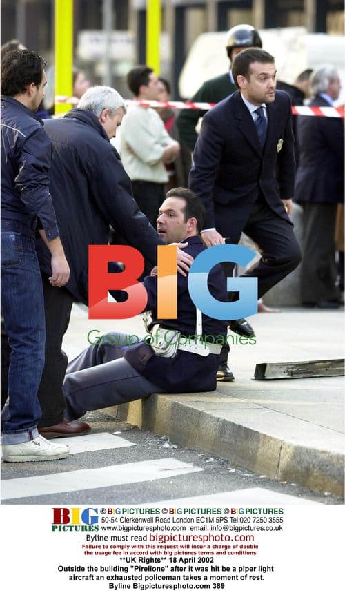 Policeman Rests After Pirellone Building Plane Crash