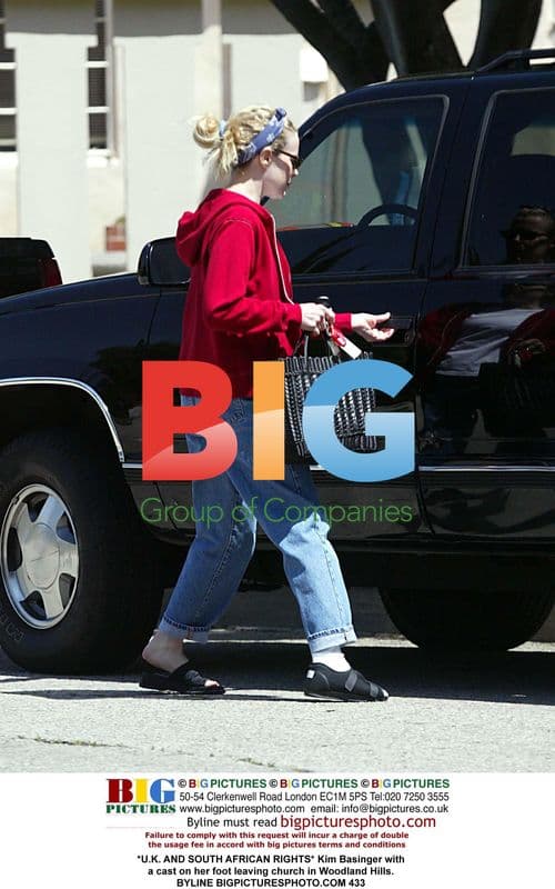 Kim Basinger leaving church with foot cast