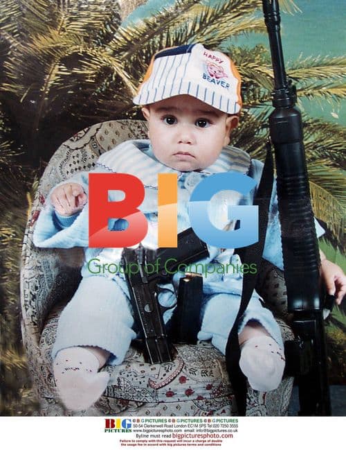 IDF Soldier Holds Photo of Baby with Guns