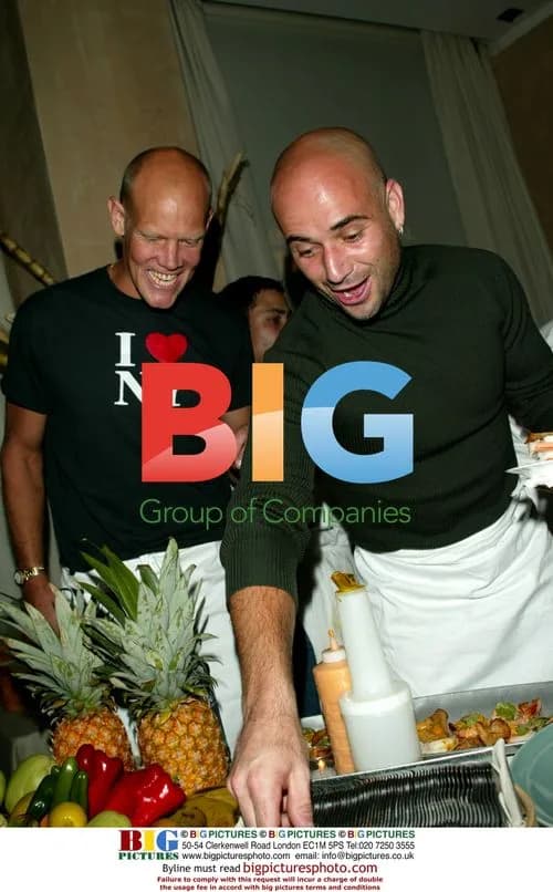 Andre Agassi serves hors d'oeuvres at benefit