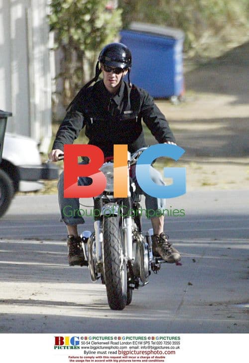 Keanu Reeves takes out trash on motorcycle