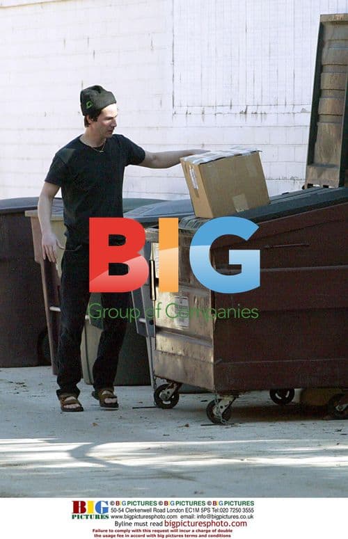 Keanu Reeves takes trash to dumpster