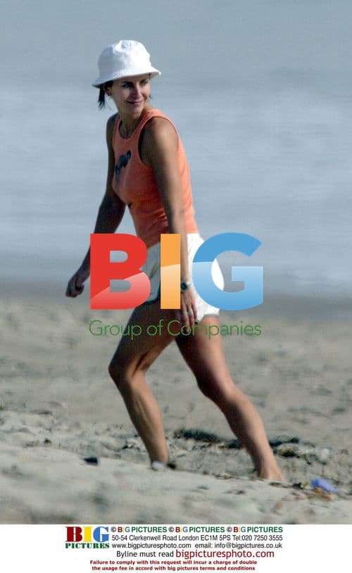 Courteney Cox with puppy on Malibu beach