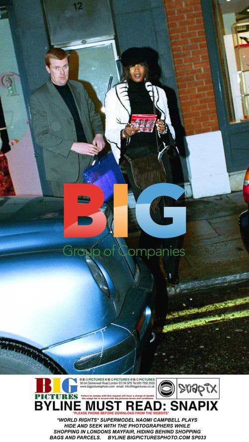 Supermodel Naomi Campbell hides from paparazzi in London