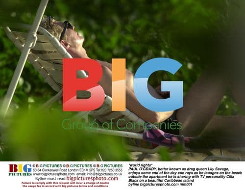 Paul O'Grady, aka Lily Savage, relaxing on Caribbean beach