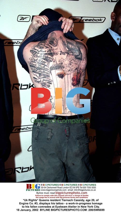 Firefighter Tiernach Cassidy shows tattoo