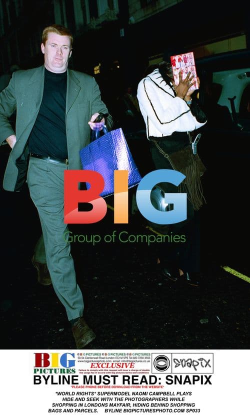 Naomi Campbell Hides from Paparazzi While Shopping