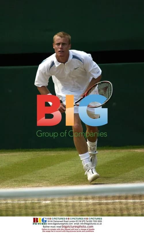 Lleyton Hewitt charges the net at Wimbledon