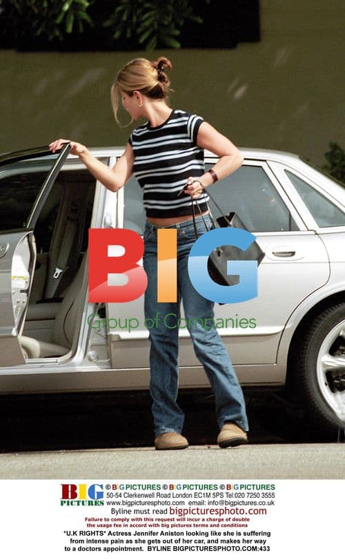 Jennifer Aniston exits car in apparent pain