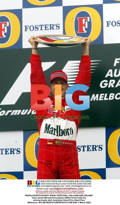 Michael Schumacher Holds Trophy Aloft at Australian GP