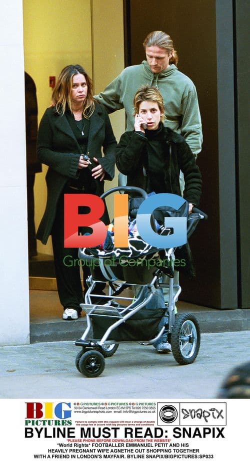 Footballer Emmanuel Petit and his pregnant wife shopping