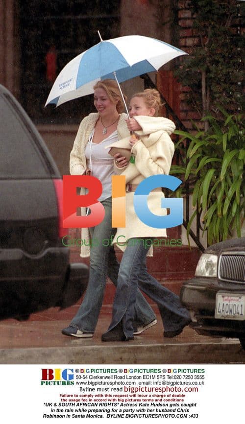 Kate Hudson caught in rain with husband