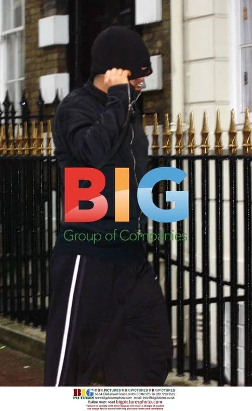 Robbie Williams Arrives Wearing Perspex Mask