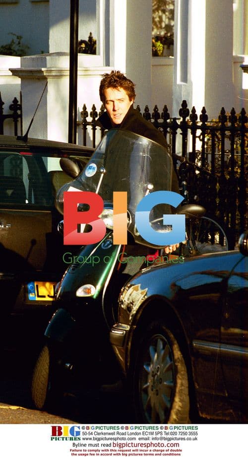 Hugh Grant getting newspapers in London