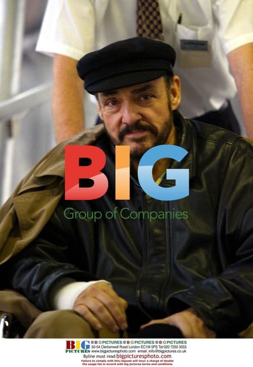 John Rhys-Davies in wheelchair on return flight