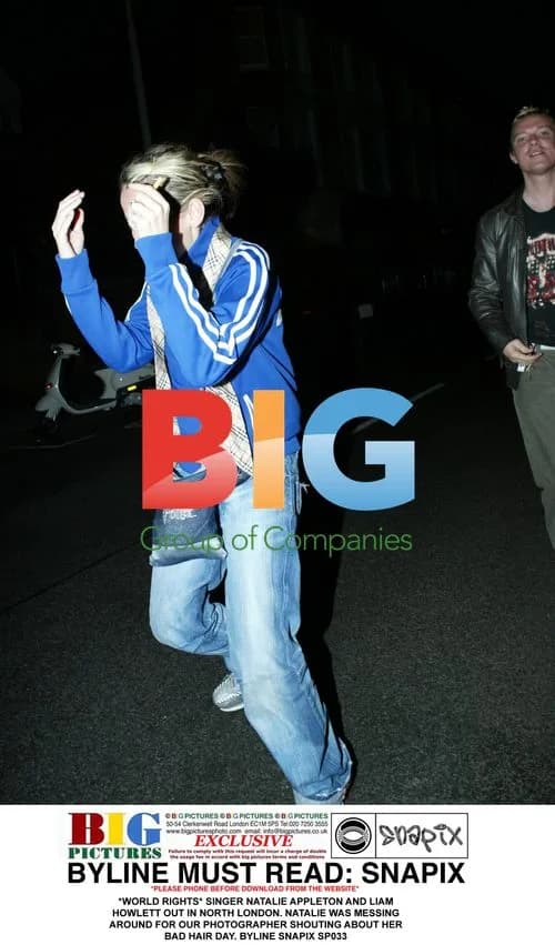 Singer Natalie Appleton having fun with photographer