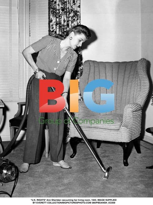 Ann Sheridan vacuums living room in 1943