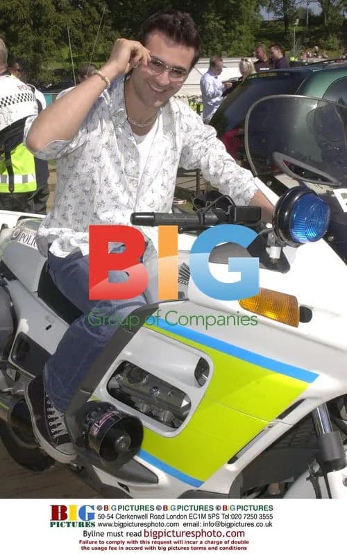 Singer Darius poses on police motorbike
