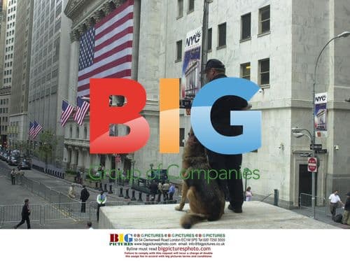 Pedestrians walk by Wall Street on 9/11 anniversary