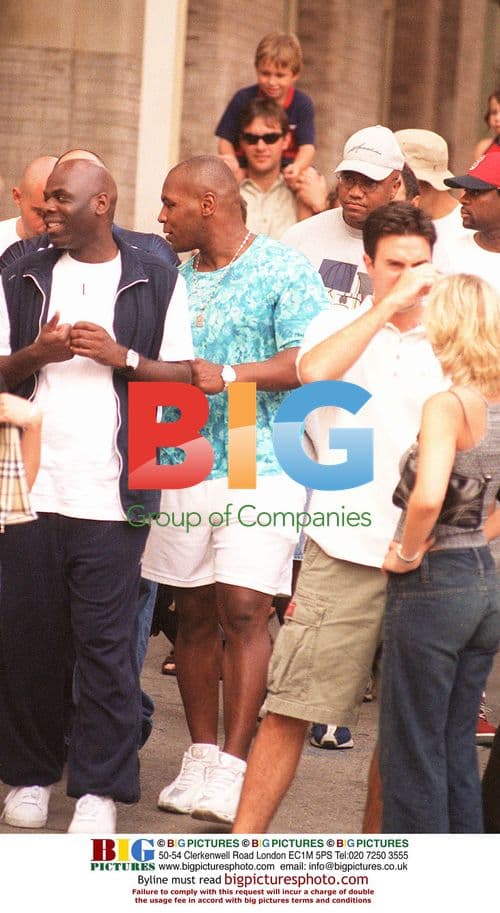 Boxer Mike Tyson flanked by bodyguards