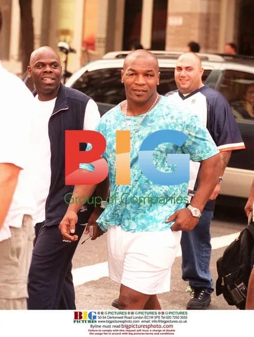 Mike Tyson Flanked by Bodyguards in Soho