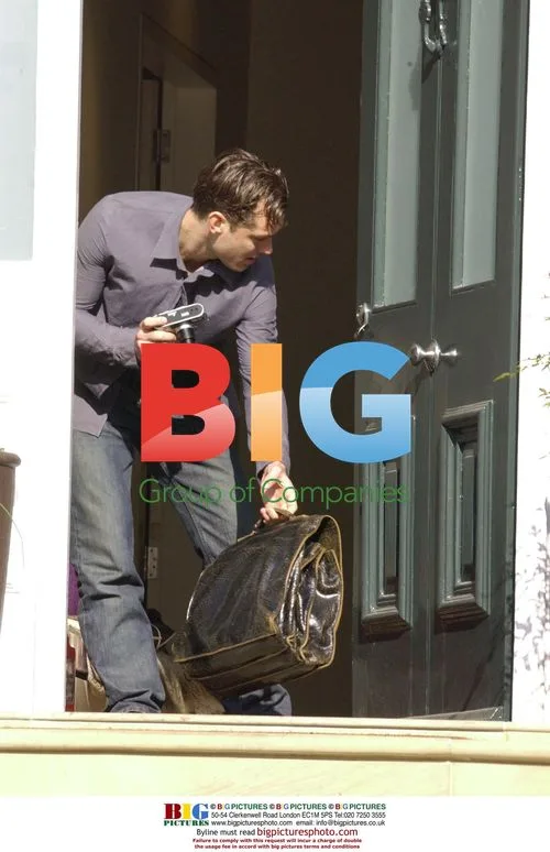 Jude Law Leaves London Home with Camera