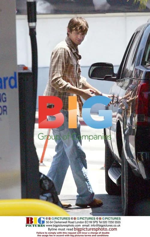 Ashton Kutcher Pumps Gas for Fan