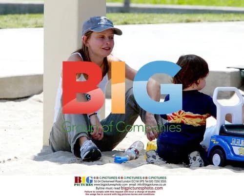 Calista Flockhart plays with son Liam in sandpit