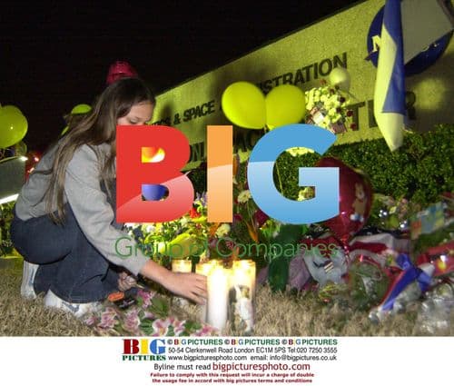 Adriana Garcia lights candle at shuttle memorial