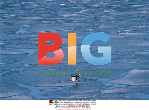 Man ice fishing on Flathead Lake