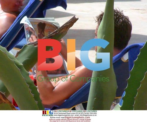 Gary Neville Reading by Pool in Malta