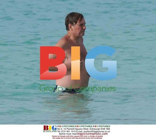 Jonathan Aitken Strolls Alone on Caribbean Beach