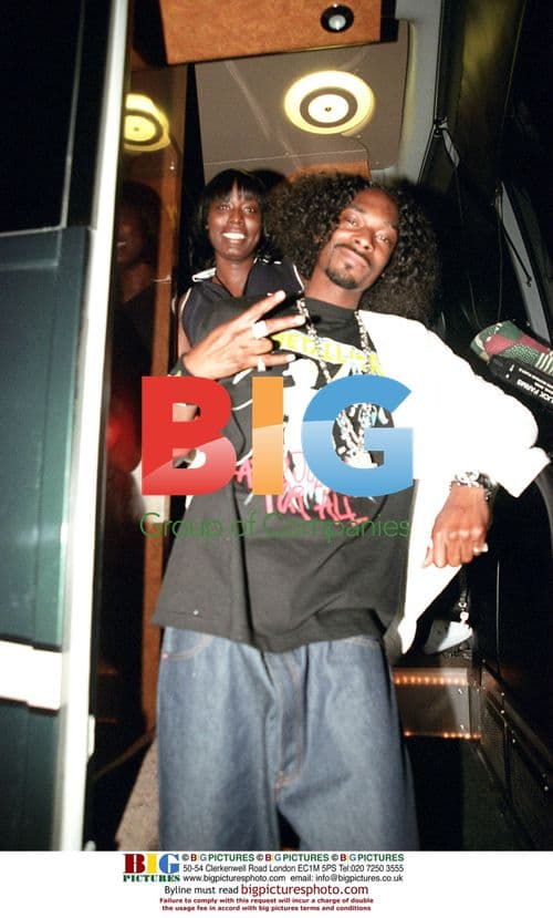 Snoop Dogg poses in tour bus