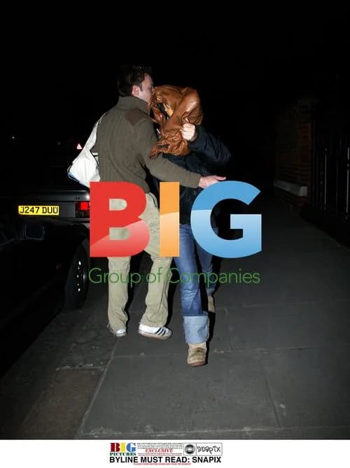 Geri Halliwell hides behind bag with friend