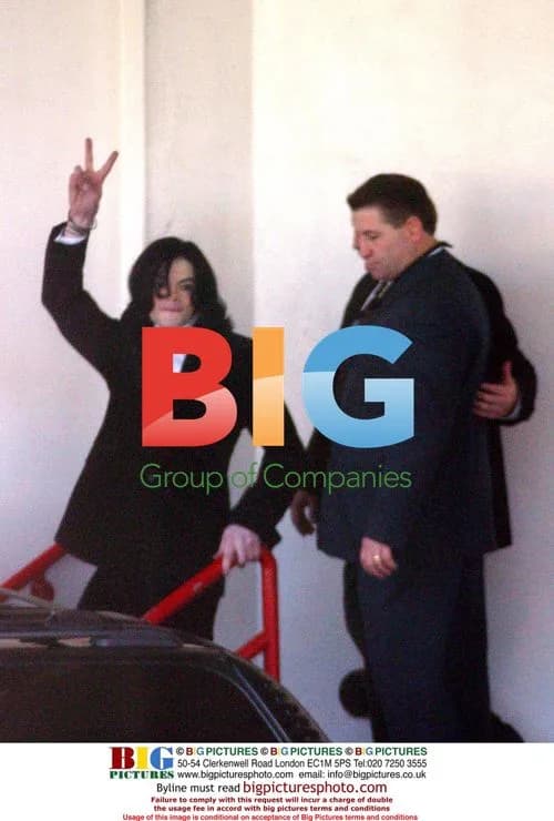 Michael Jackson waves after being booked on charges