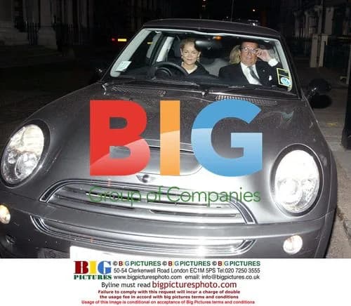 Sir Roger Moore and wife at birthday party