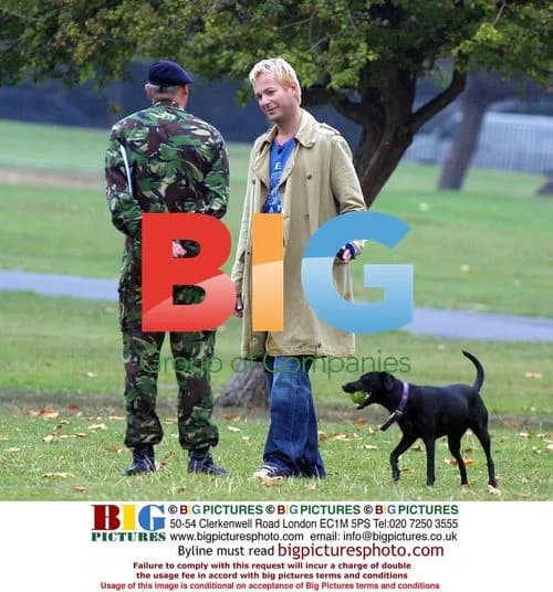 Julian Clary with dog Valerie in park