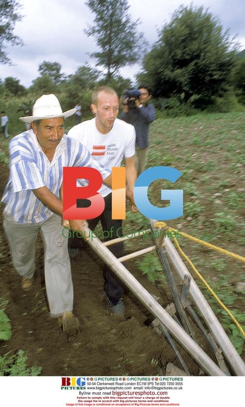 Chris Martin helps plow field in Mexico