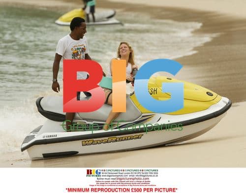 Abi Titmuss Rides Jet Ski on Beach