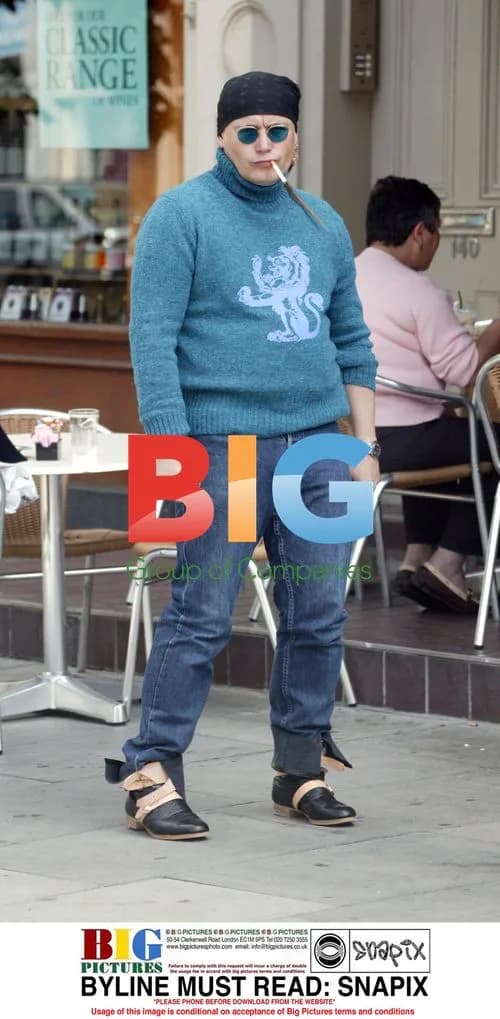 Adam Ant smoking outside cafe in London