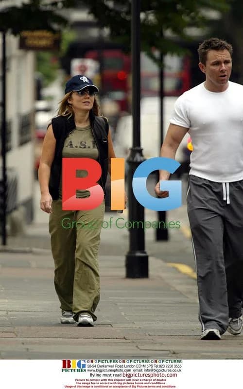 Geri Halliwell Hides Behind Trainer in London