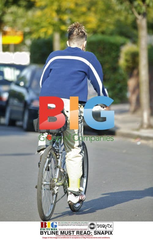 Limahl Riding Bike in North London