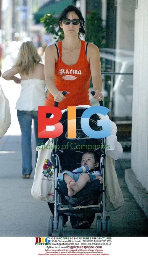 Carrie Ann Moss walks with baby