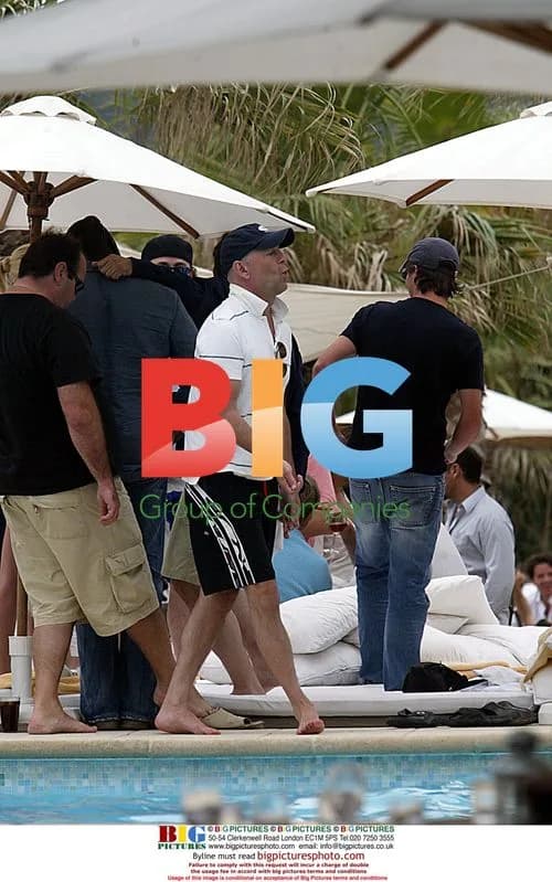 Bruce Willis plays air guitar with girls in St. Tropez