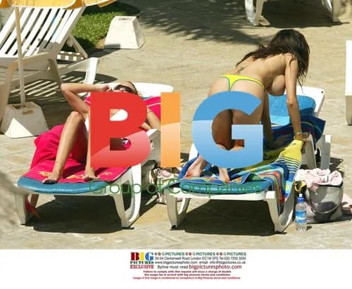 Page 3 models tanning by pool in Tenerife