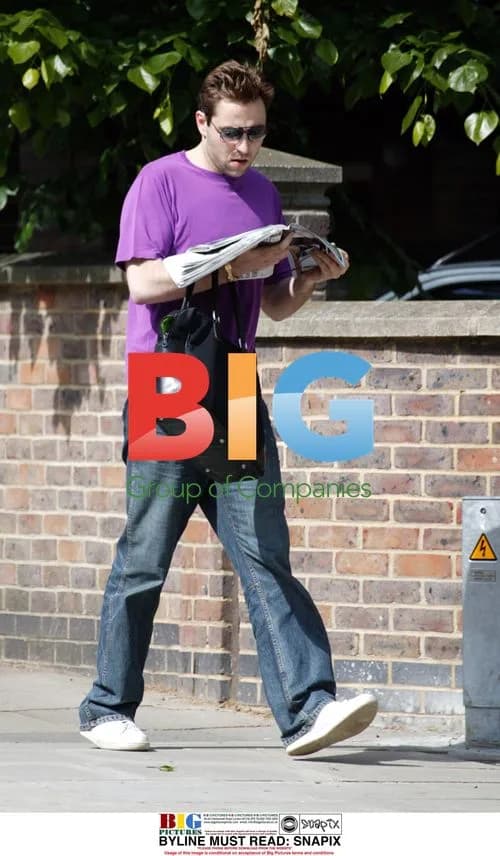 David Walliams reading newspaper in London