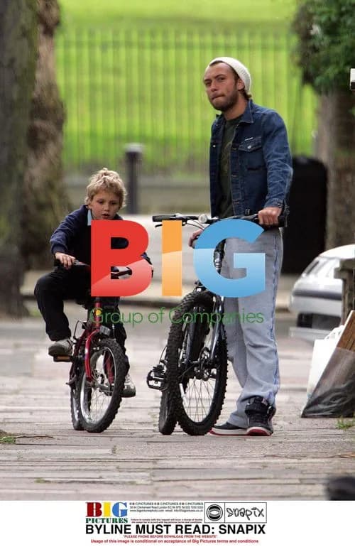 Jude Law and son Rafferty bicycling in London