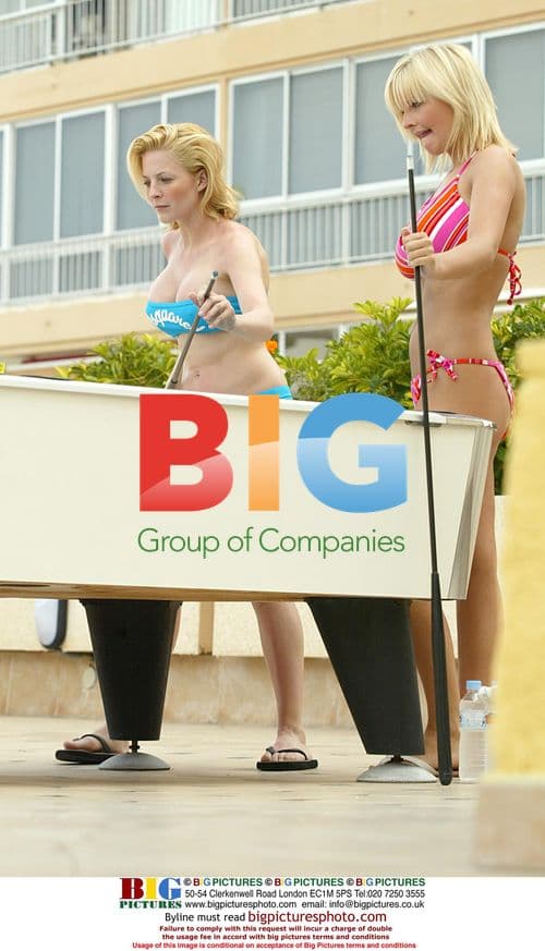 Glamour models Michelle Marsh and Jo Hicks playing snooker