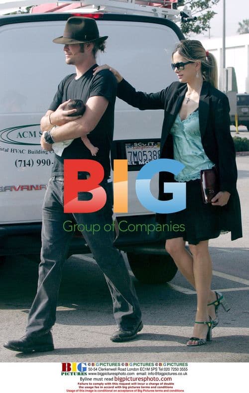 Mira Sorvino and Chris Backus with newborn daughter