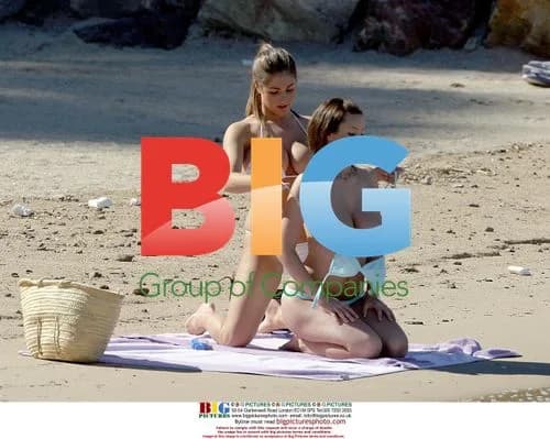 Glamour Models Relaxing on Beach